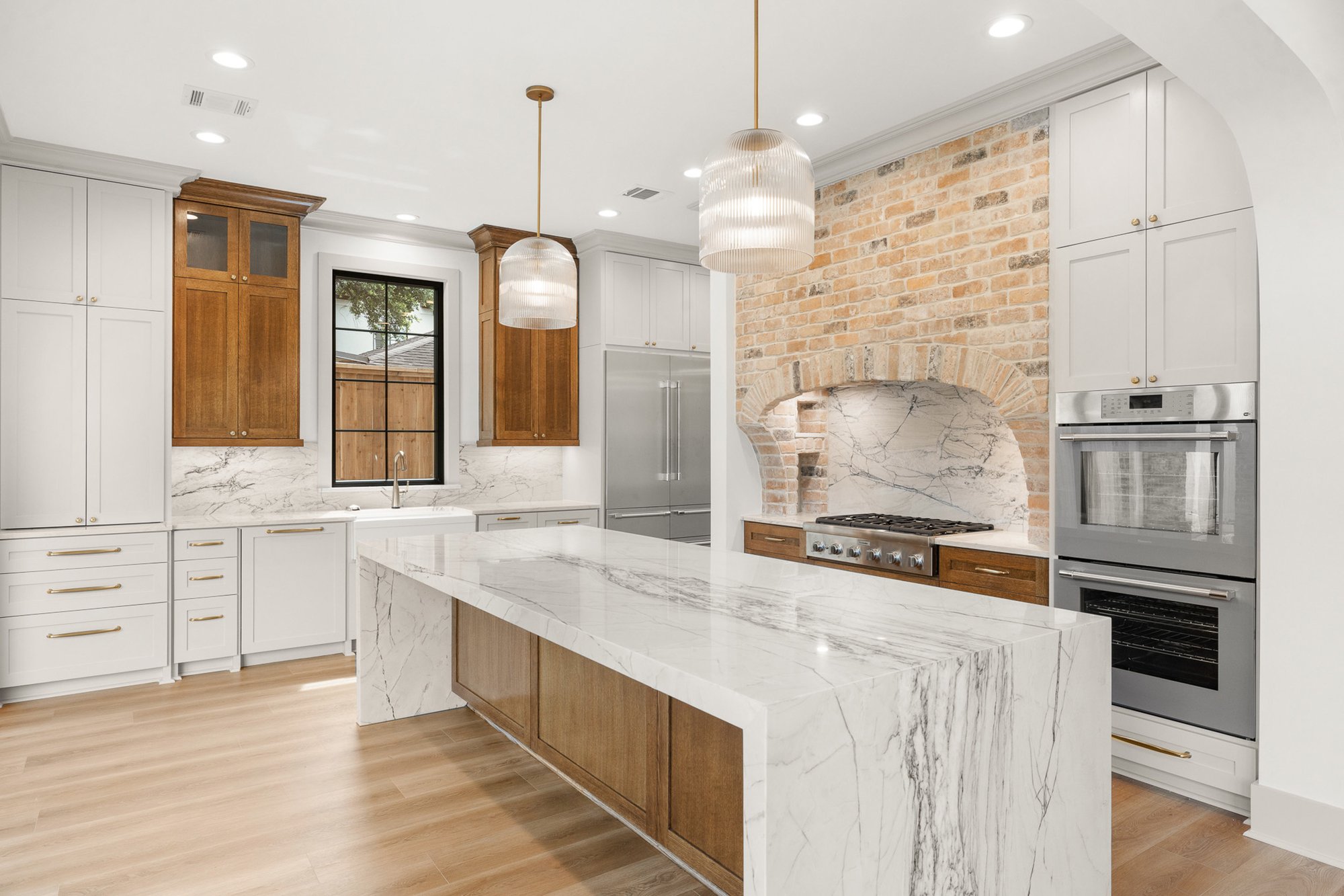 Custom kitchen with waterfall marble island Custom kitchen with waterfall marble island