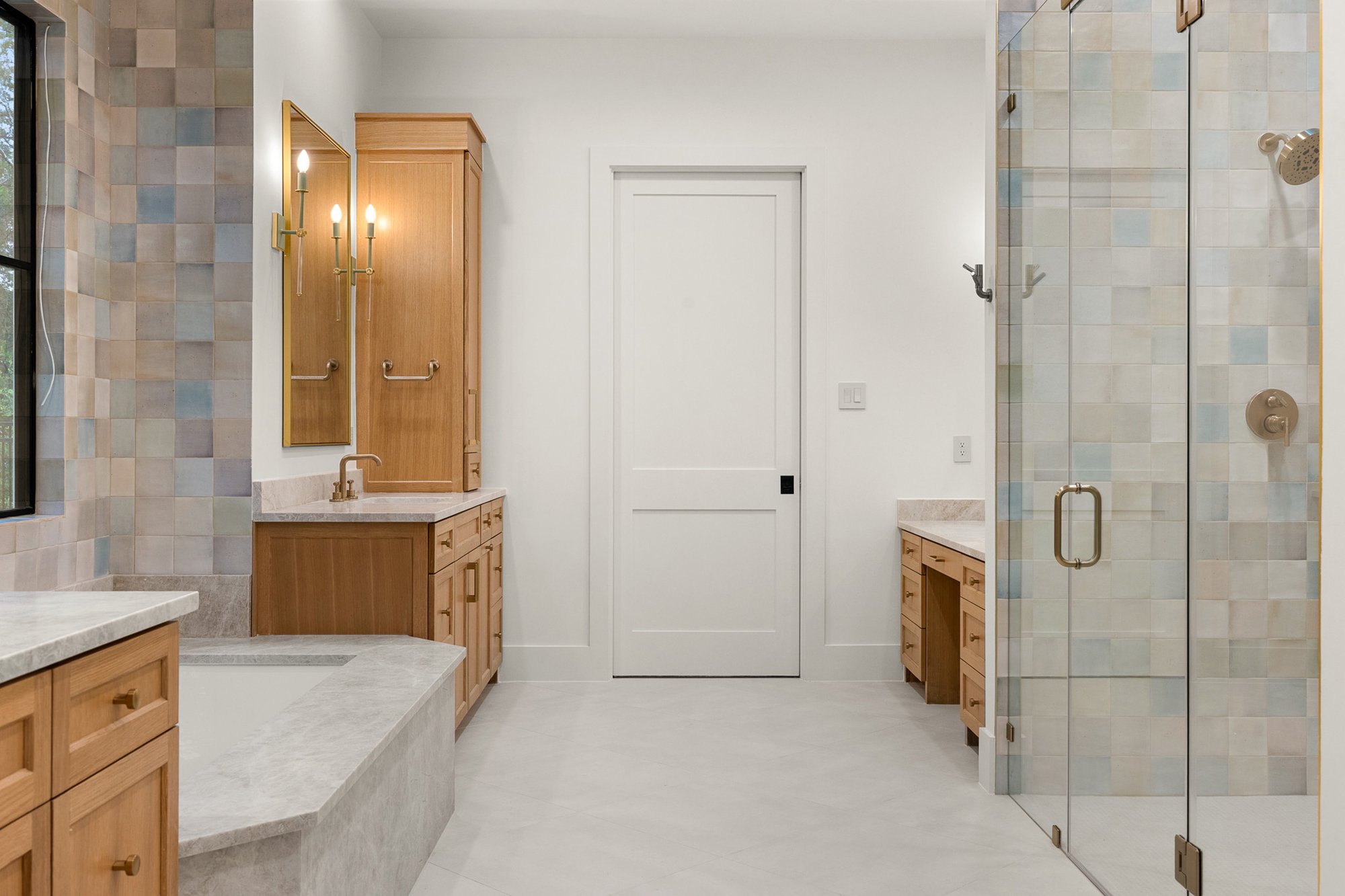 Spa-inspired primary bathroom with luxury finishes and custom cabinetry