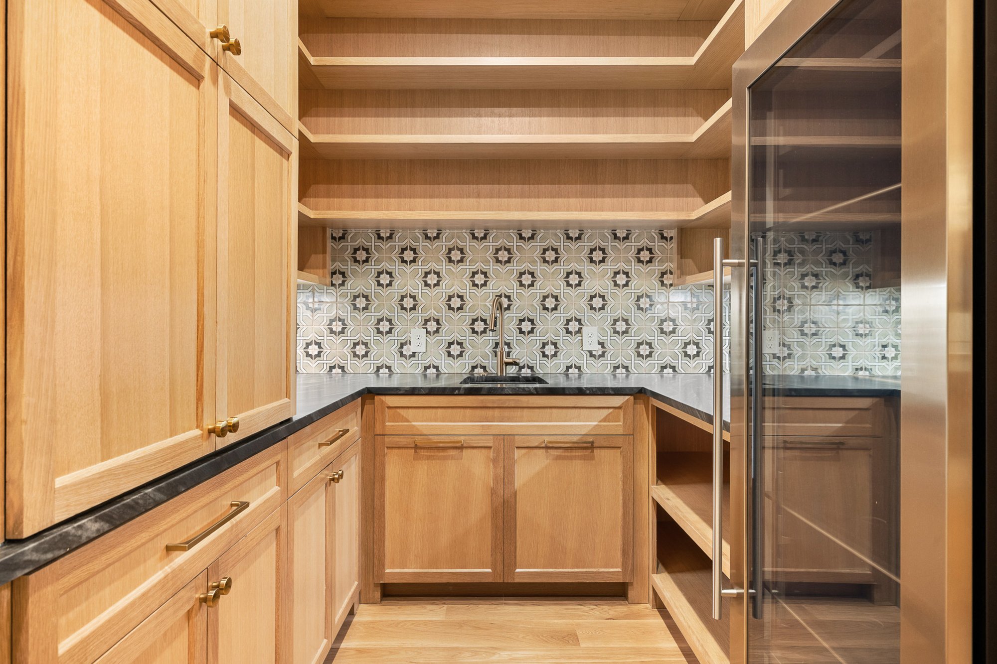 Walk-in pantry with custom shelving and abundant storage