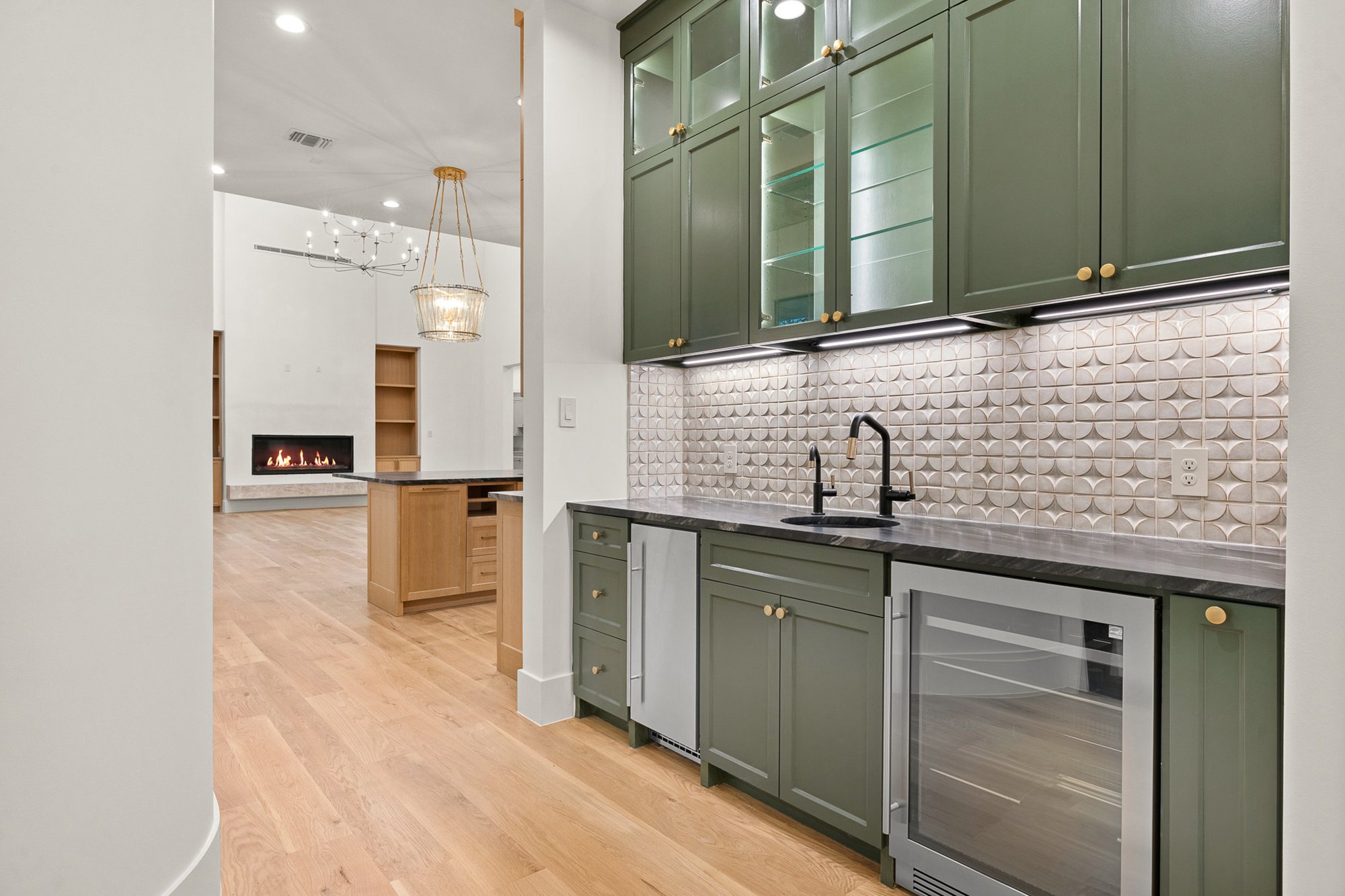 Built-in coffee and beverage station with sink and custom cabinetry