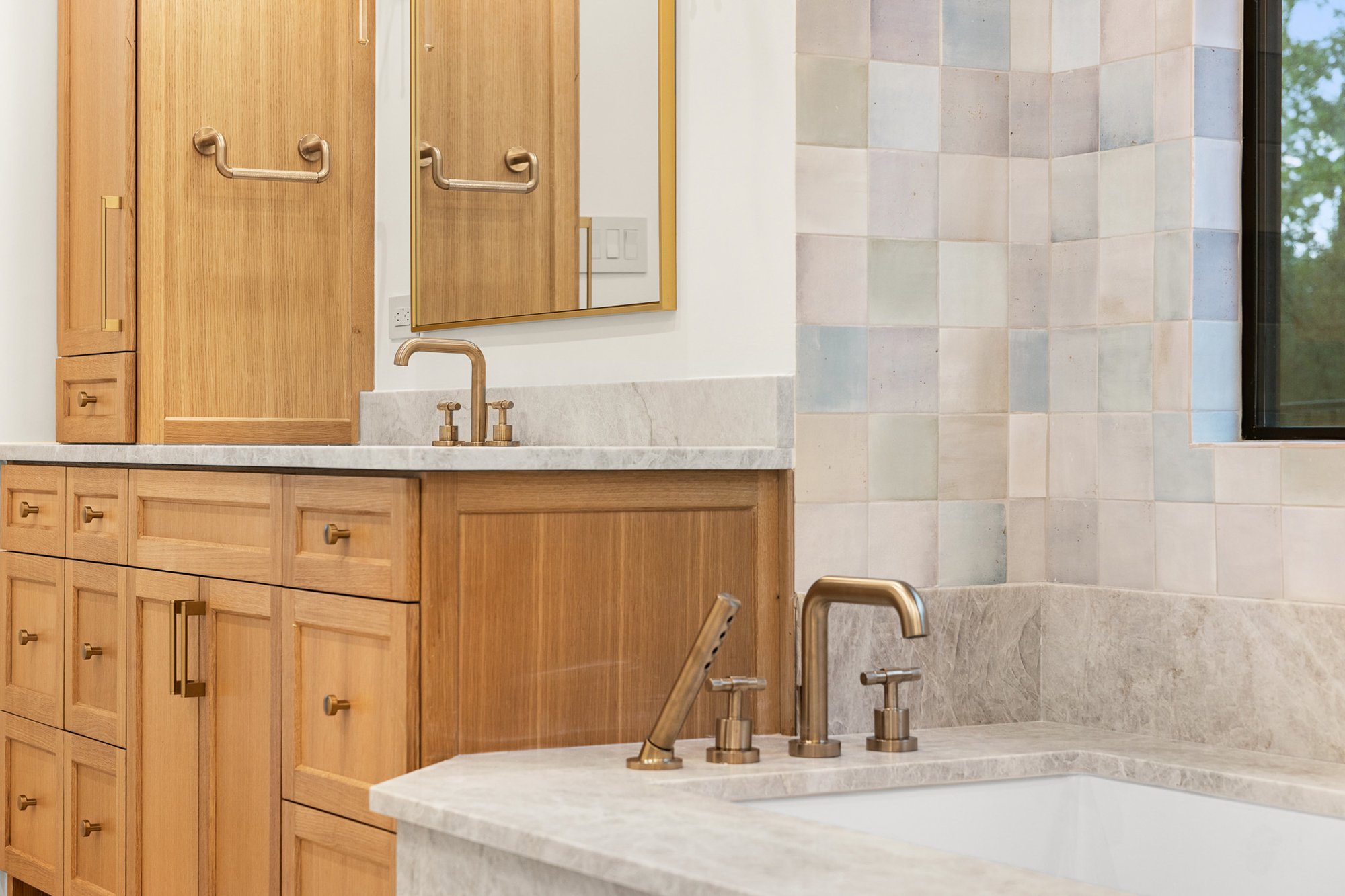 Spa-inspired primary bathroom with luxury finishes and bath