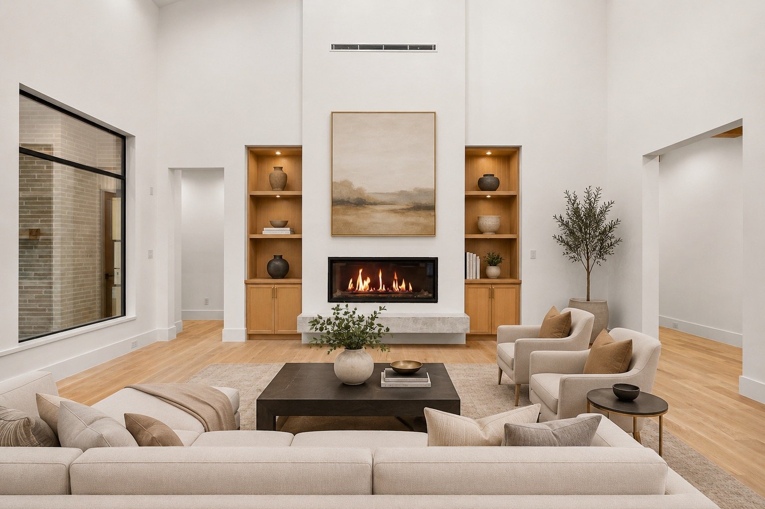 Open-concept living room featuring a custom plaster fireplace and reclaimed white oak beams