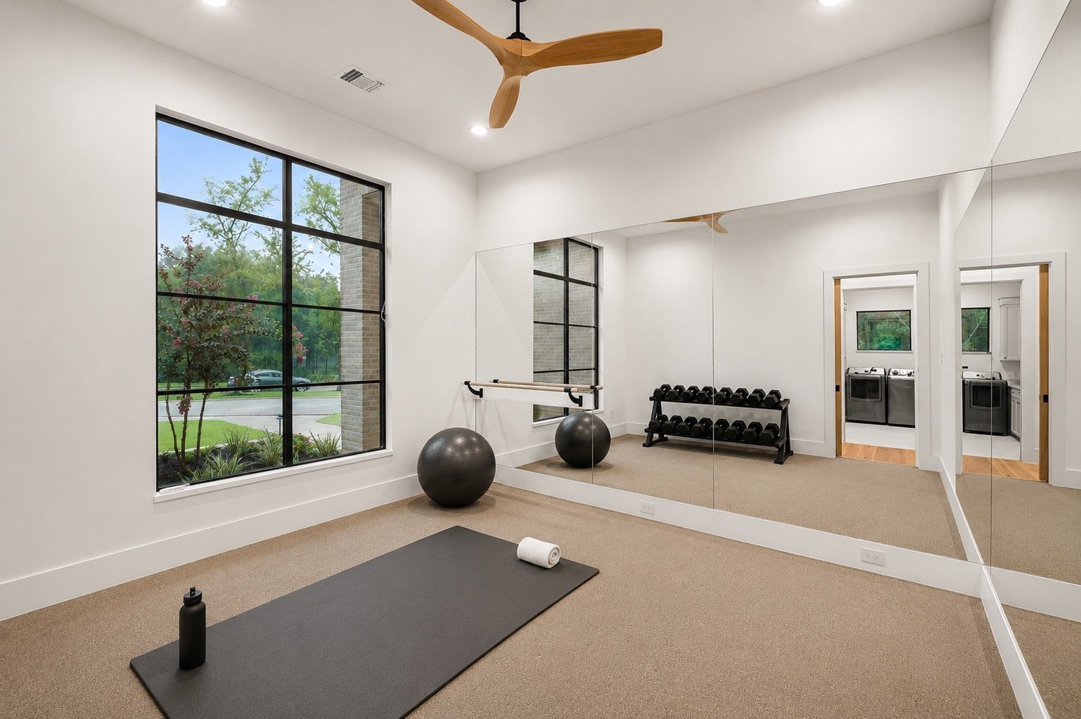 Dedicated home exercise room featuring a barre