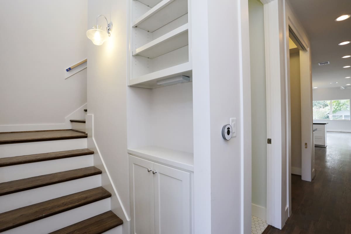 Custom Built Storage Space and Shelves Alongside A Staircase