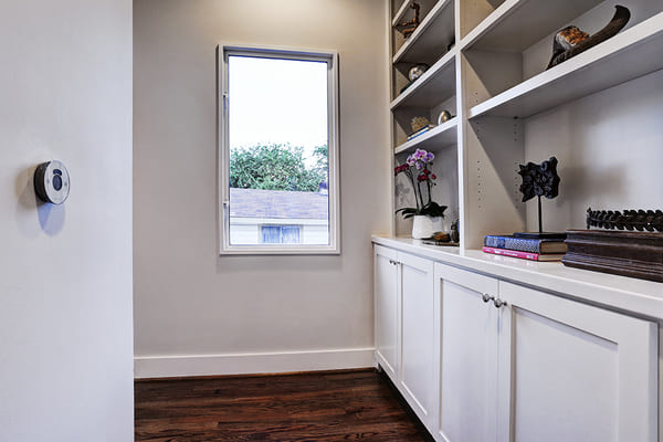 Custom Built White Cupboard Stoarge Space and Shelves Overlooking Upstairs Window