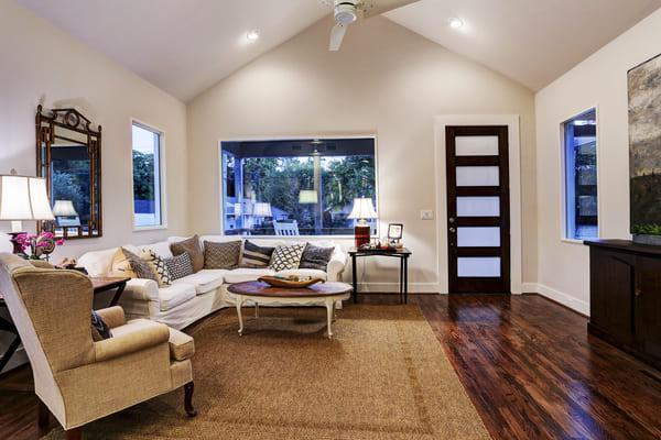 Spacious Farmhouse Living Room With A Custom TV Stand And A Sectional Couch