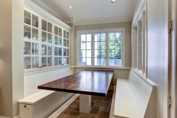 Built-in table in front of glass front storage