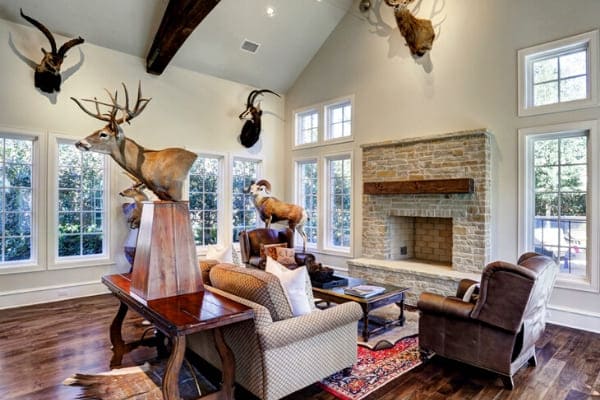 Custom fireplace in Houston, Texas surrounded by animal trophies