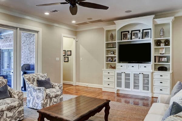 Custom white entertainment center in remodeled living room in Houston, Texas