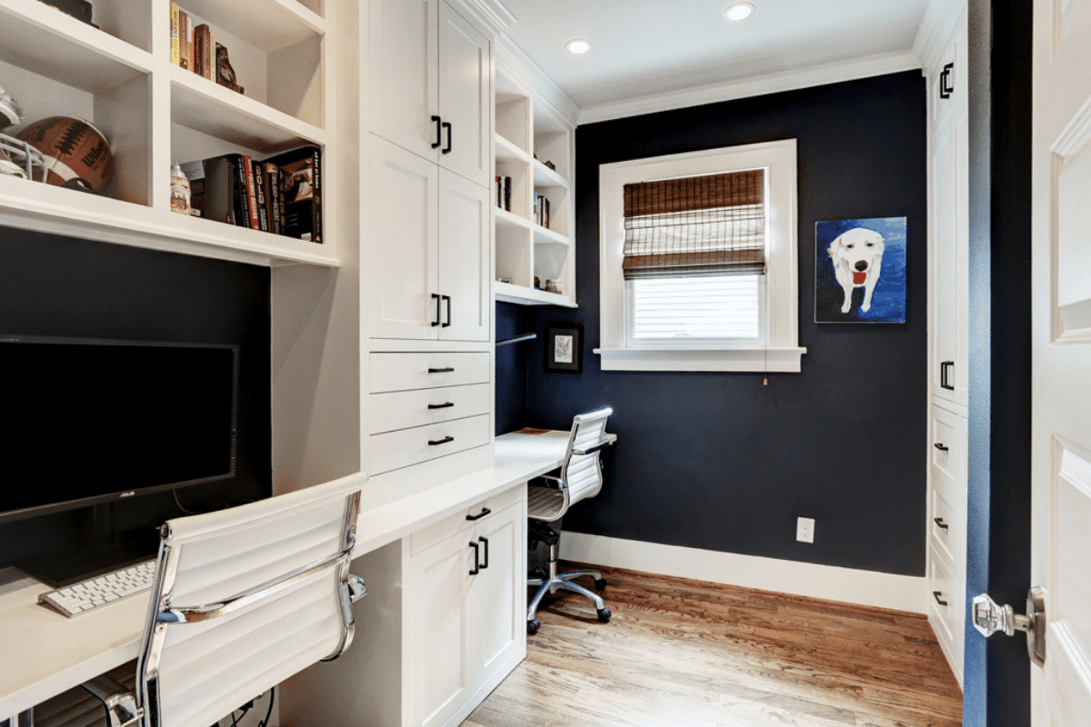 A Custom Built Desk with White Cabinets and Blue Walls