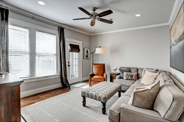 A Custom Home Living Room with a Sectional couch and Brown Leather Chair