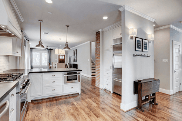 Custom Home in Houston with Wooden Floors and White Cabinets in the Kitchen