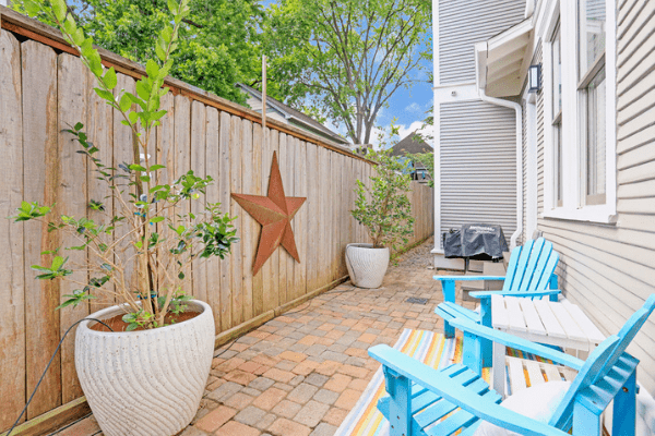 Houston Heights Backyard with the Texas Star on the Fence and Two Blue Patio Chairs