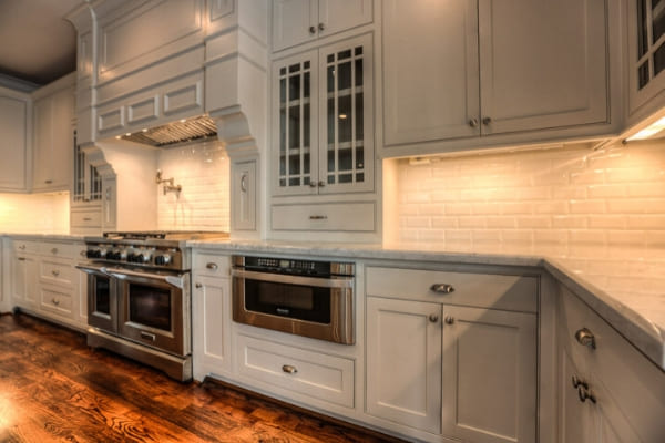 New kitchen appliances and white subway tile back splash in custom Houston kitchen