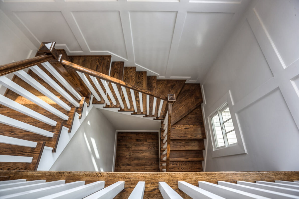 Wooden staircase in Houston luxury home by Southern Green Builders