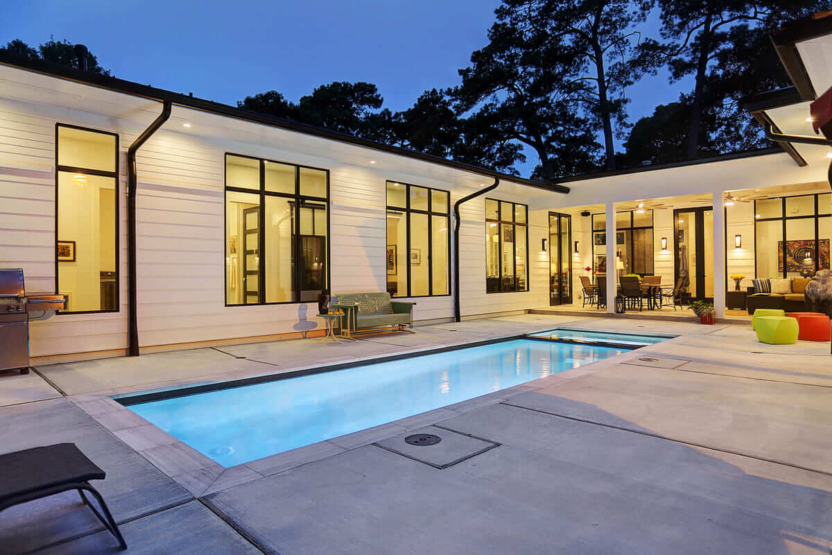 Outdoor inground pool with spacious surround and pool lounge chairs