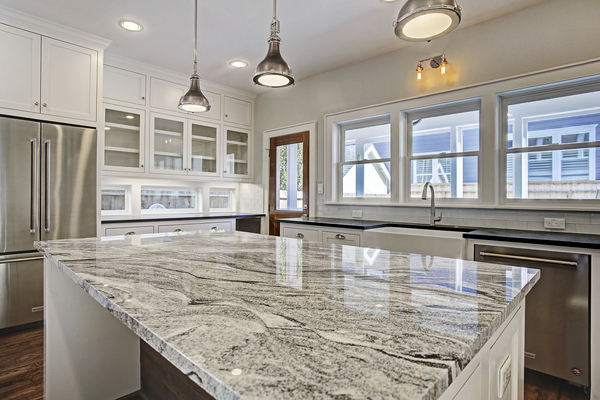 Luxury Kitchen Island with Marble Countertops and Industrial Light Fixtures